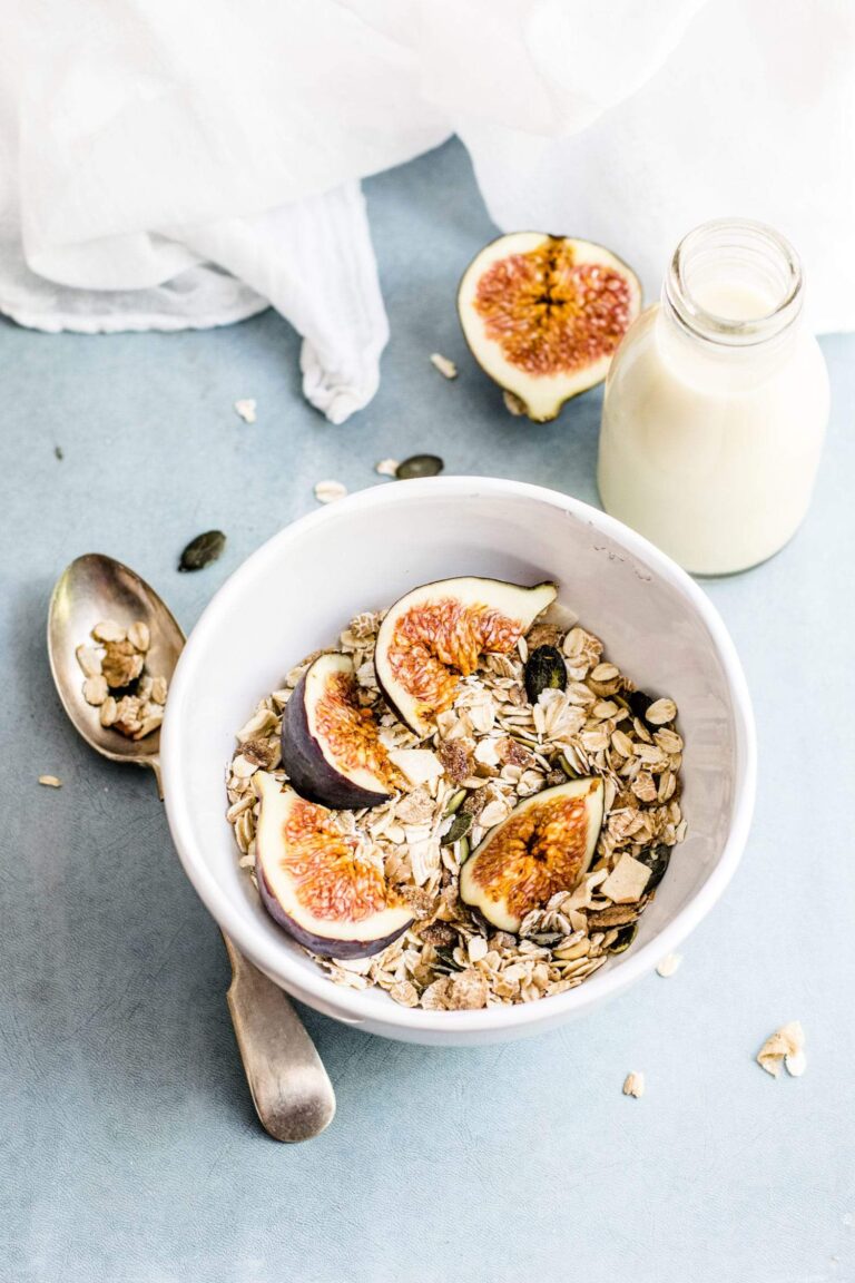white-bowl-with-kefir-granola-and-figs-on-a-blue-counter