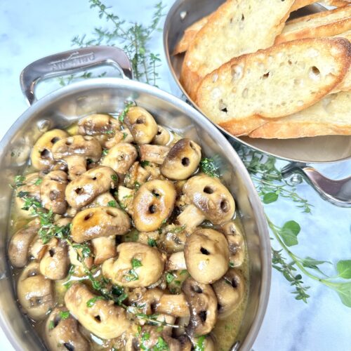 mushrooms made to look like skulls served in all clad stainless stell oval baker severed with crostini and garnished with herbs