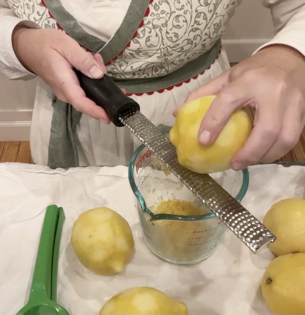 Woman zesting lemons for lemonade
