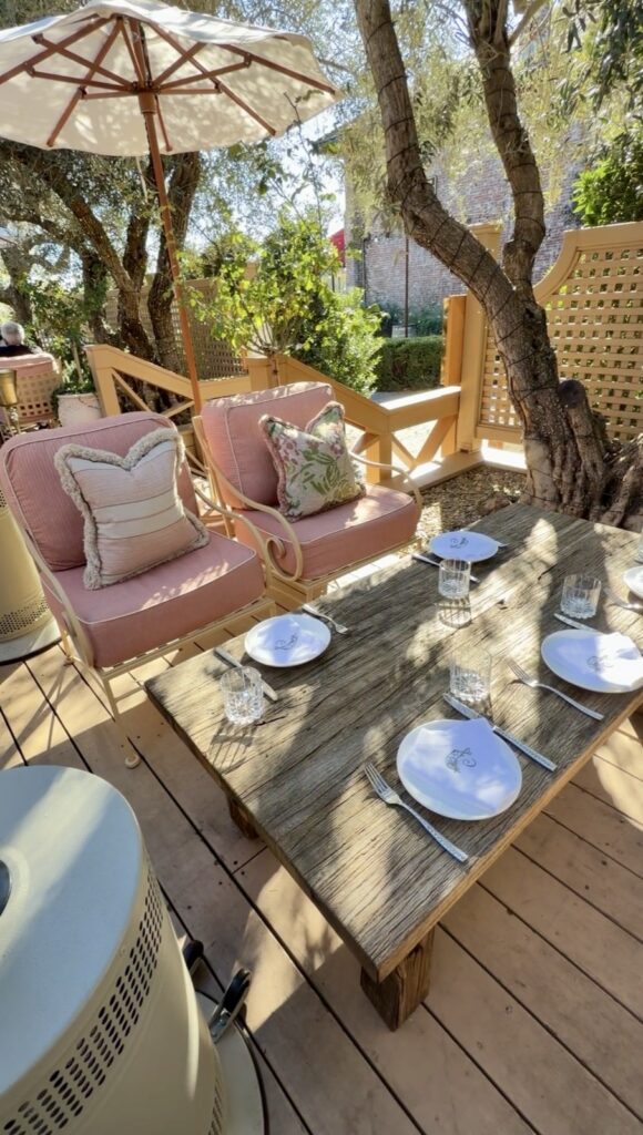 Clementine Yountville outdoor patio dining European Café French Riviera inspiration with a olive tree growing out of the deck