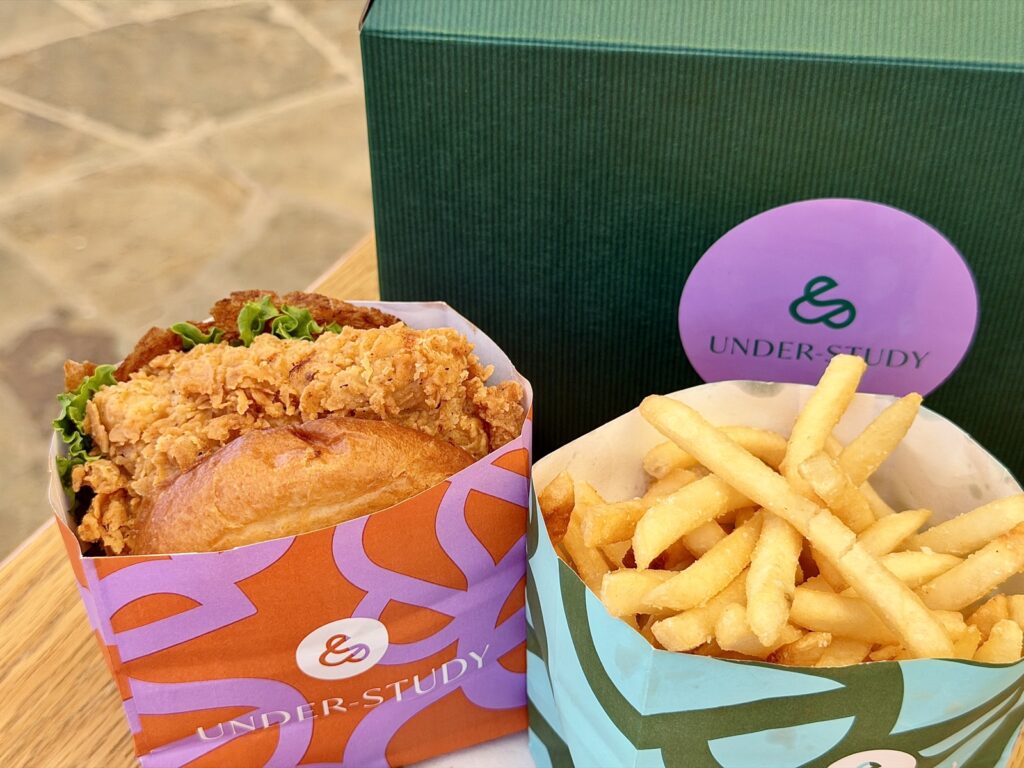 A picture of a bougie box from understudy Saint Helena with a fried chicken sandwich and French fries.