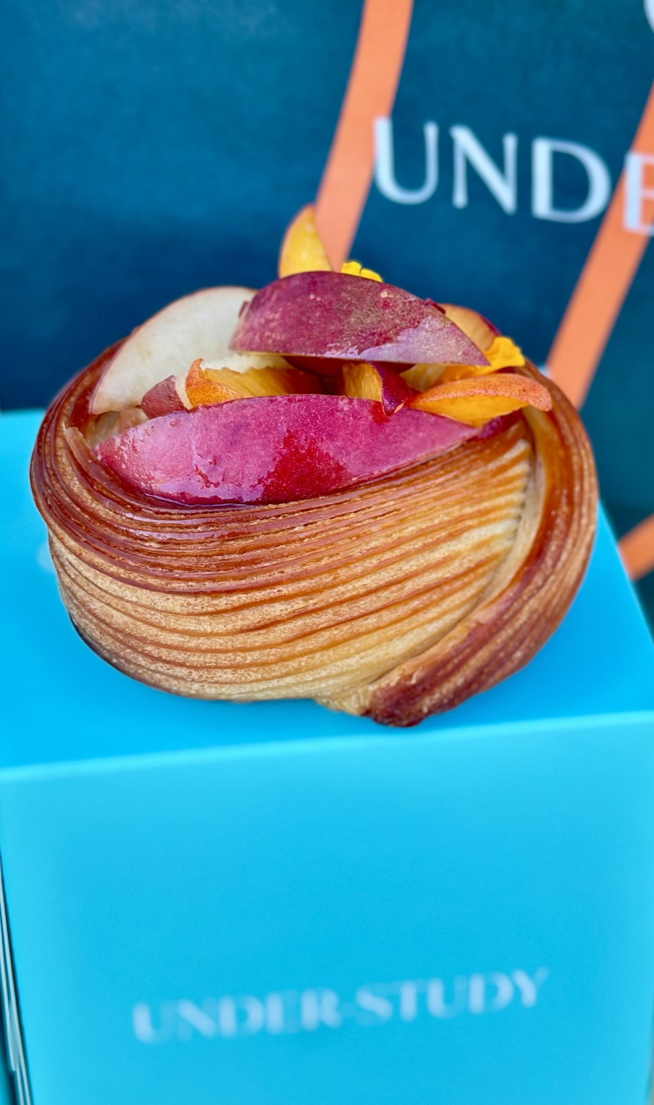 Picture of under study Saint Helena, Napa valley's seasonal danish photographed on top of their signature blue pastry box.