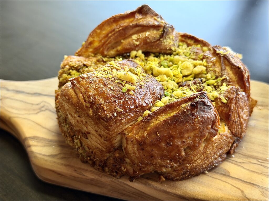 A picture of a baklava bun with pistachios and walnuts from Butter and Crumble in San Francisco
