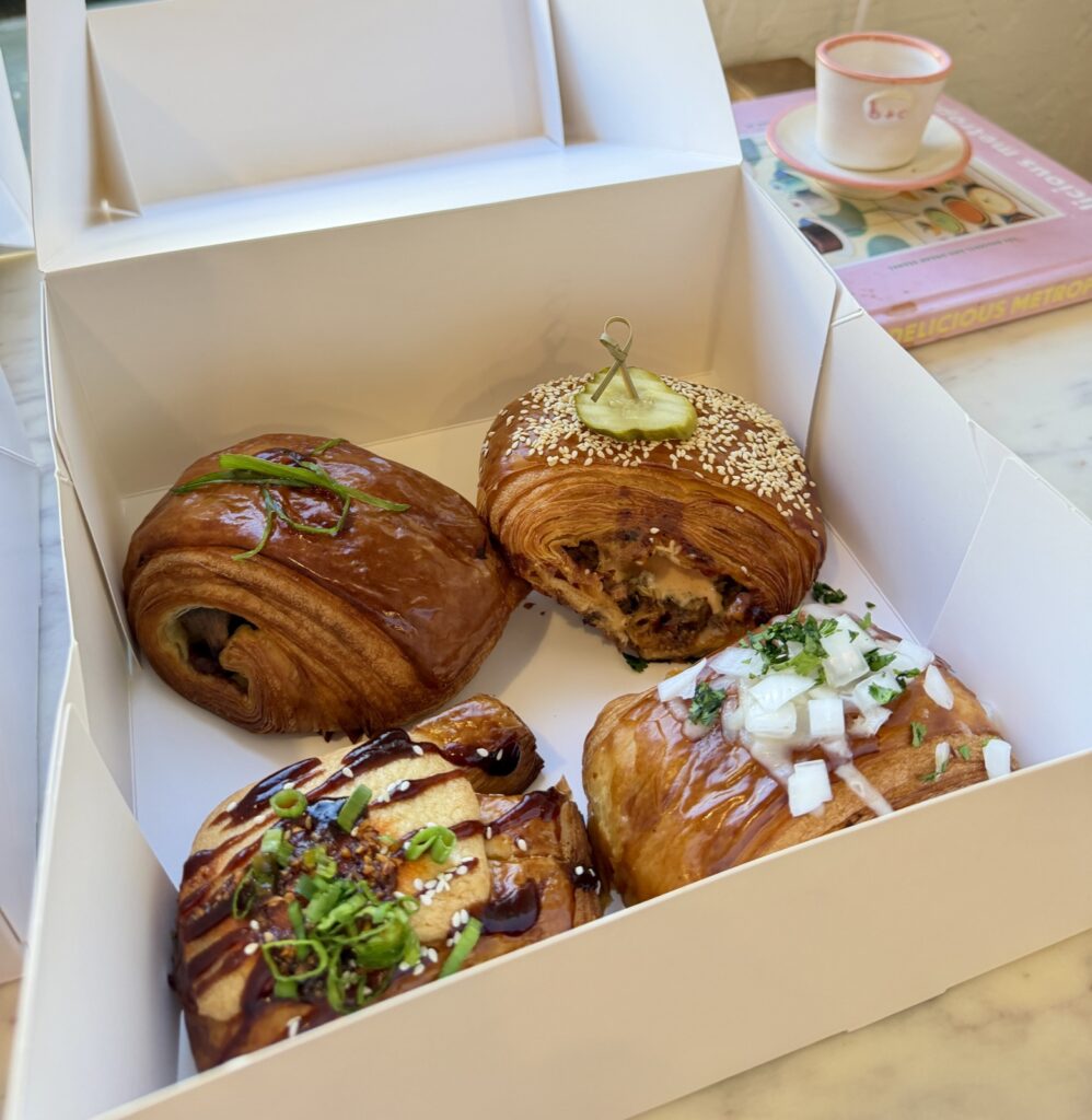 A picture of four savory pastries from Butter and Crumble in San Francisco inside of an open pastry box