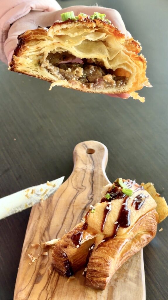 A picture of a cross-section showing the filling in butter and crumbles pork bun.