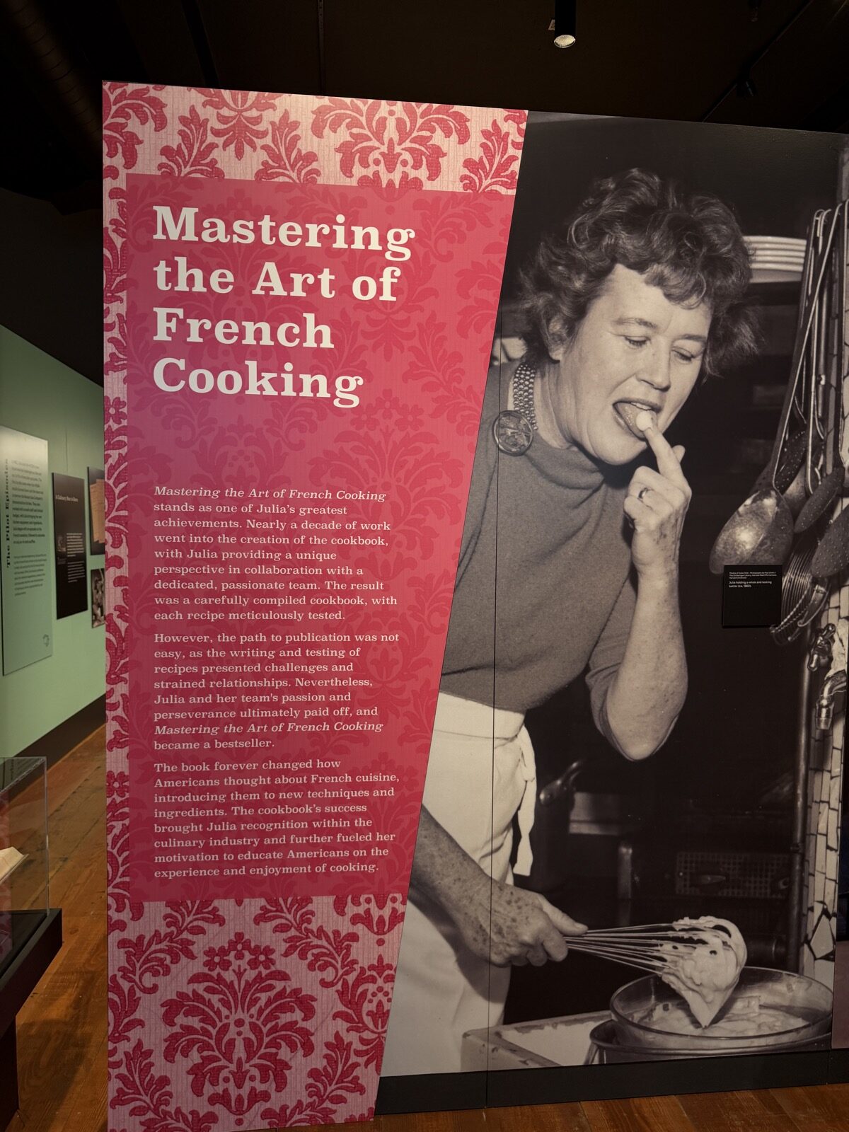 A picture from the Julia Child: A Recipe for Life exhibit, Julia whisking and checking how it tastes