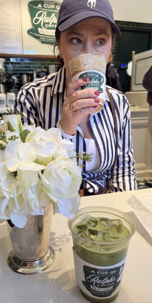 A woman in a blue and white Ralph Lauren dress drinking an iced latte with a Ralph's coffee, coffee collar