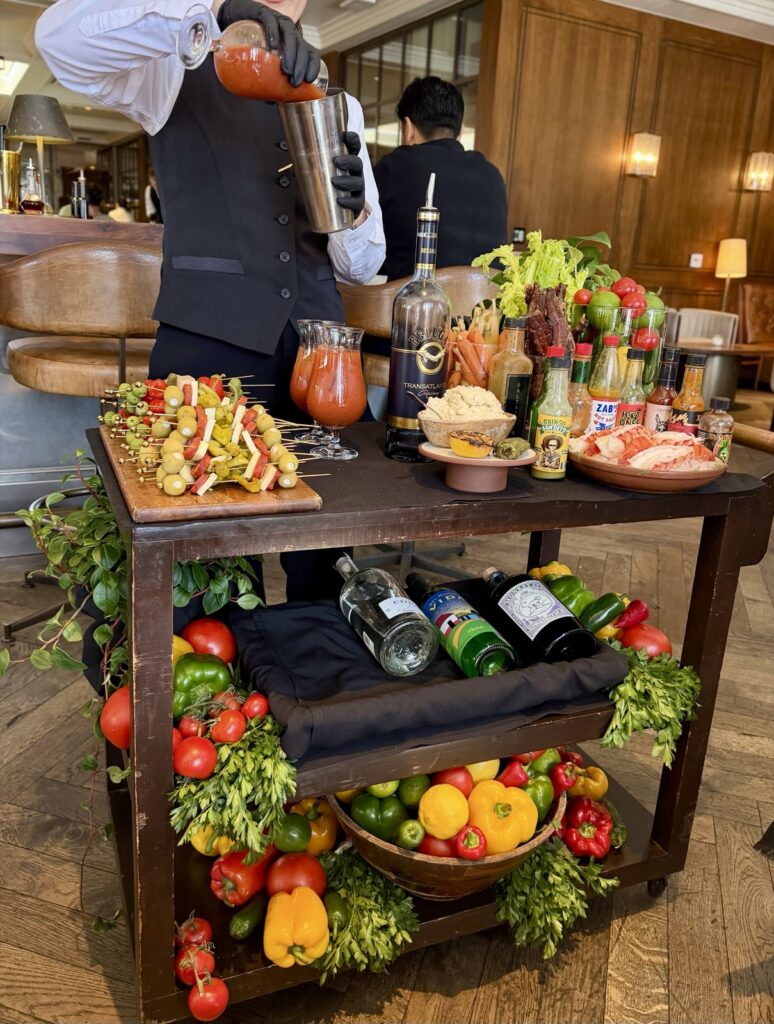A picture of the Bloody Mary kart at Baltaire, mixing a Bloody Mary in a shaker