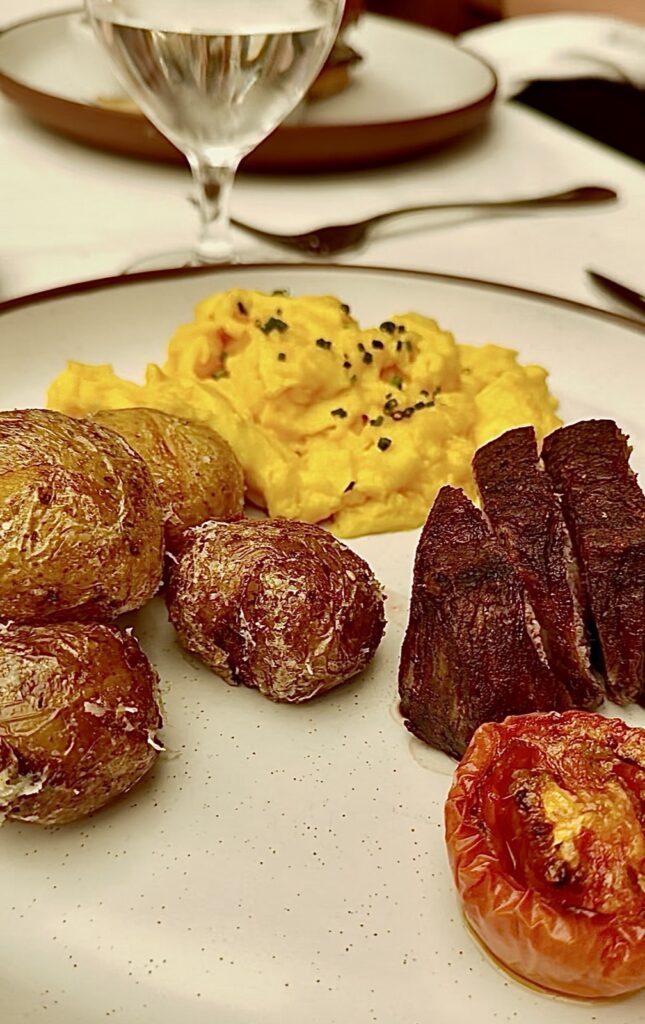 Brunch at Baltaire, a picture of steak and eggs with roasted potatoes and a roasted tomato