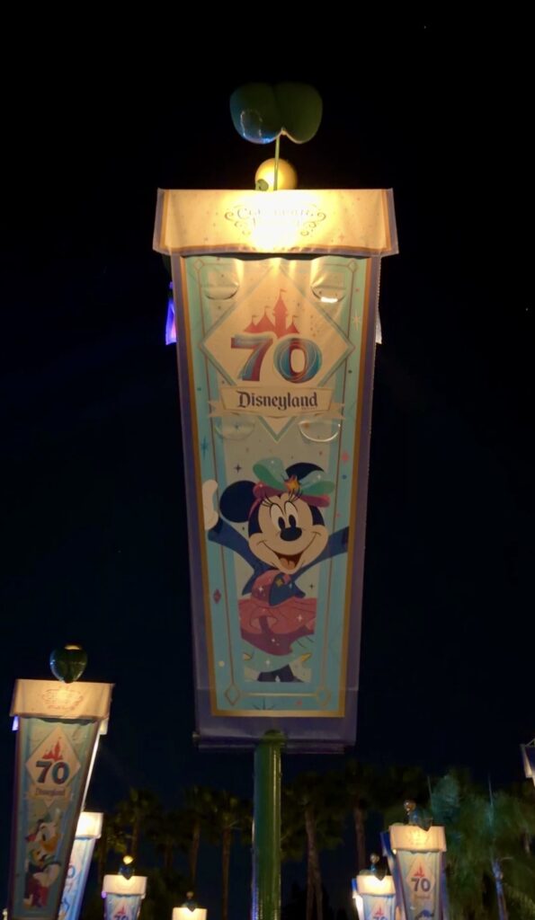 This is a picture of a Disneyland 70th anniversary celebration banner featuring Minnie mouse. It was located in the corridor between the gates of Disneyland and Disney's California adventure.