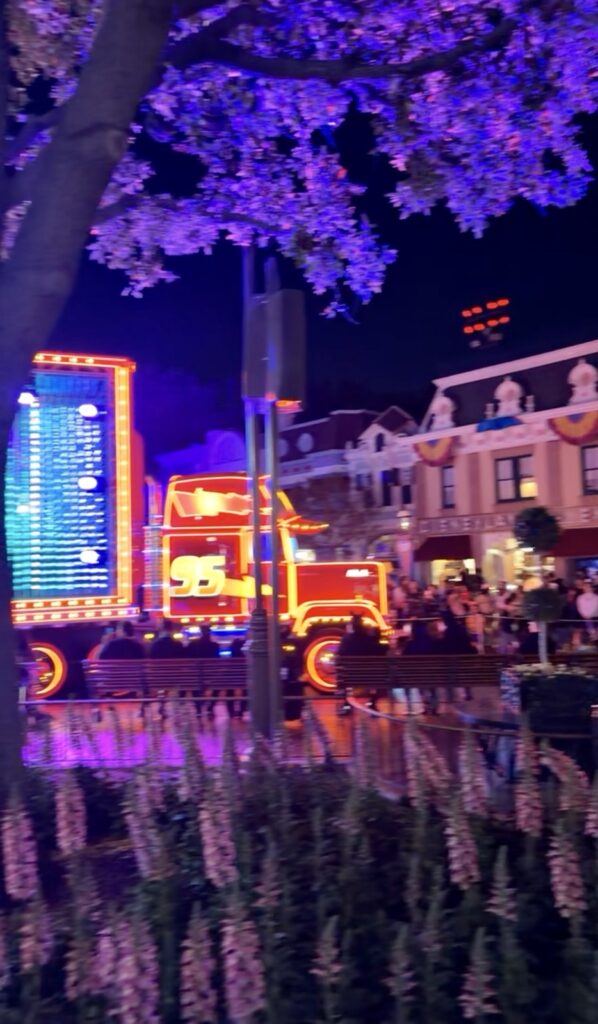 A picture of Disneyland 70th anniversary celebration paint the night parade Mac from cars.