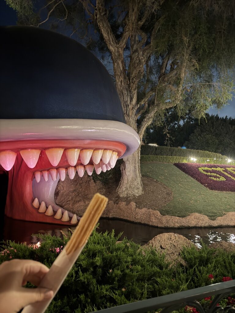 A picture of the Storybook Whale eating a churro.