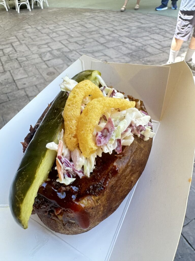 A picture of a loaded baked potato from Troubadour Tavern at Disneyland. The BBQ potato.
