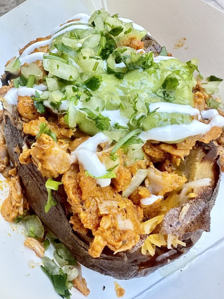 A picture of a loaded baked potato from Troubadour Tavern at Disneyland. The Una Papa Loca loaded potato.