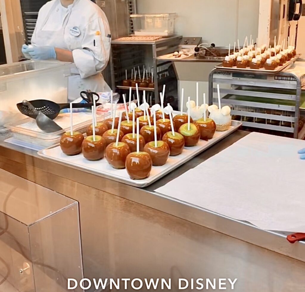 A picture of caramel apples being made in downtown Disney Disneyland.