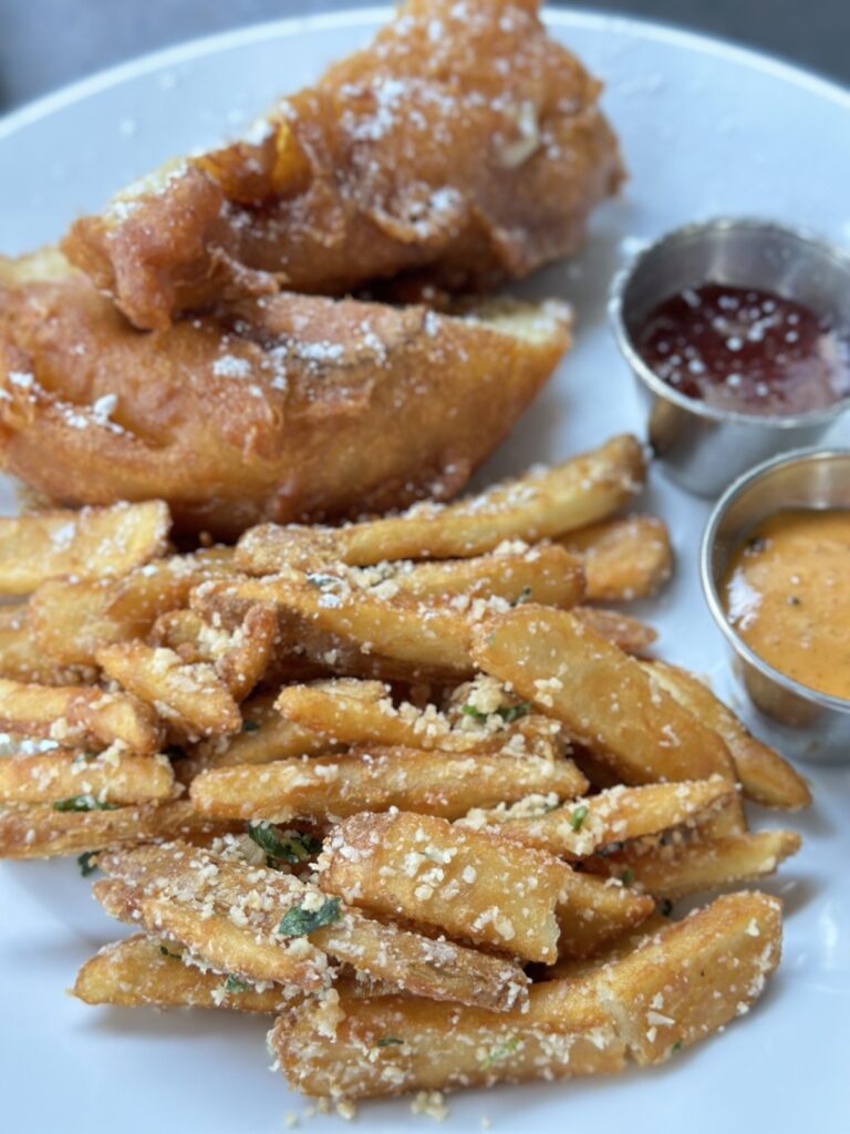 A picture of pommes frites (garlic Parmesan fries) from Café Orleans.