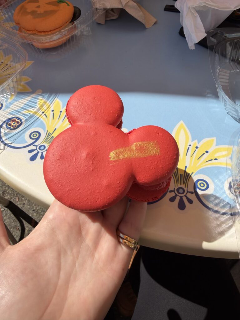 A picture of the raspberry rose Mickey-shaped macaron from Jolly Holiday bakery at Disneyland.