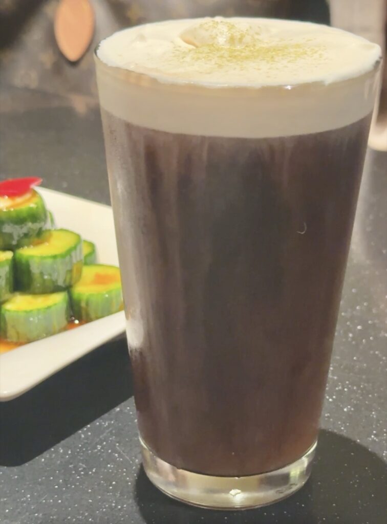 A picture of black iced tea with sea salt cream from Din Tai Fung.