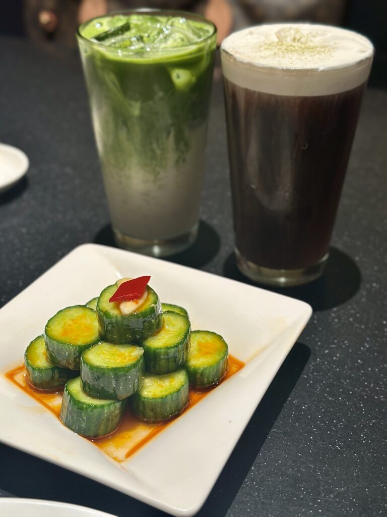 A picture of two drinks and a cucumber salad from Din Tai Fung.