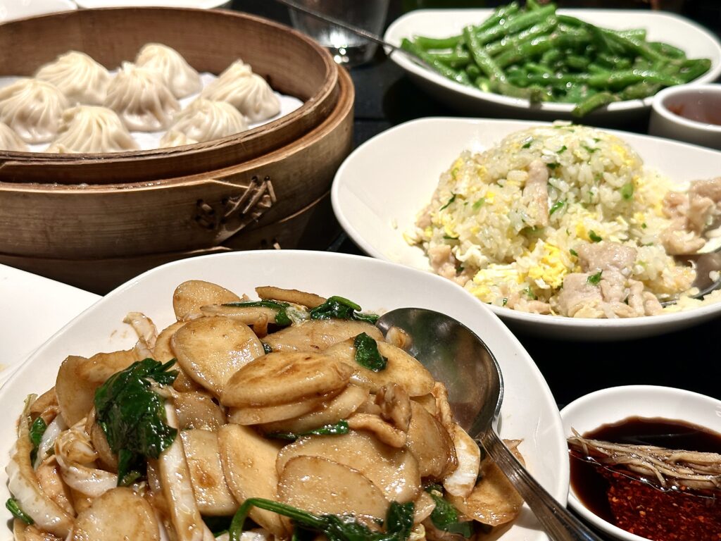 A picture of a table full of food from Din Tai Fung featuring rice cakes.