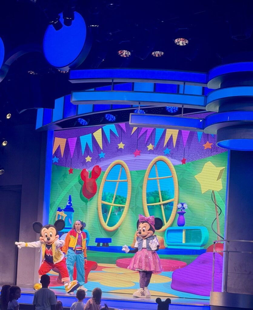 A picture of Disneyland's 70th Anniversary Disney Jr. Mickey Mouse Clubhouse with Mickey pointing at the Crowd.