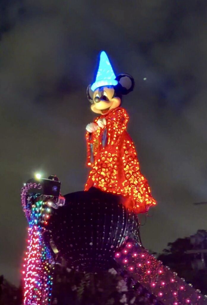 A picture of Disneyland's 70th Anniversary Paint the Night Parade of Sorcerer Mickey.