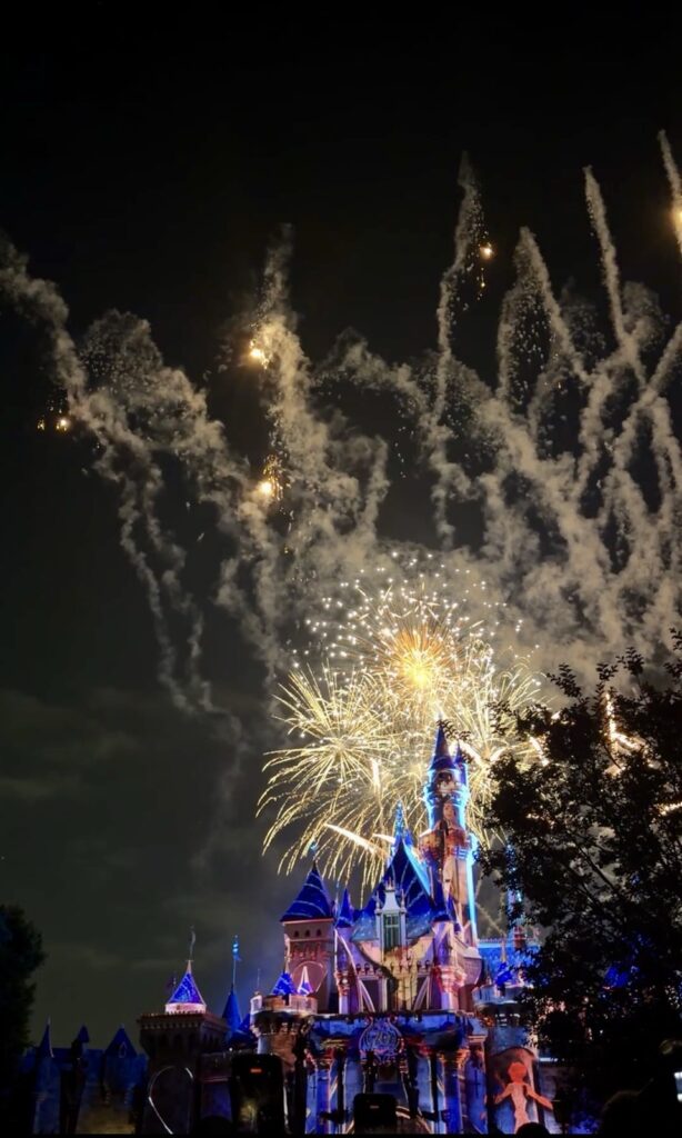 A picture of Disneyland's 70th Anniversary Wondrous Journeys Fireworks and Projection Show behind the castle.