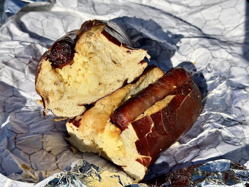 A picture of the cheesy pretzel bread with eggs and sausage cut in half from Maurice's Treats at Disneyland in Anaheim, California.
